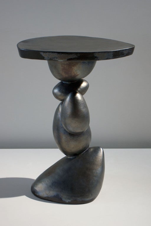 Ceramic table with metallic glazed exterior

Unique piece. 
Signed.

Born in Paris and raised in Switzerland, artist Francois Salem returned to Paris to as a teenager to join Studio Bercot for fashion design. After graduating, he traveled the