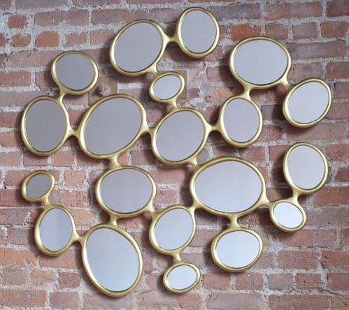 Organically shaped bronze mirror.
Available with yellow or white gold leaf finish.

Limited Edition of 25.
Signed and numbered.

Hubert Le Gall's work is a bold combination of sophisticated and playful. Inspired by the likes of Salvador Dali,