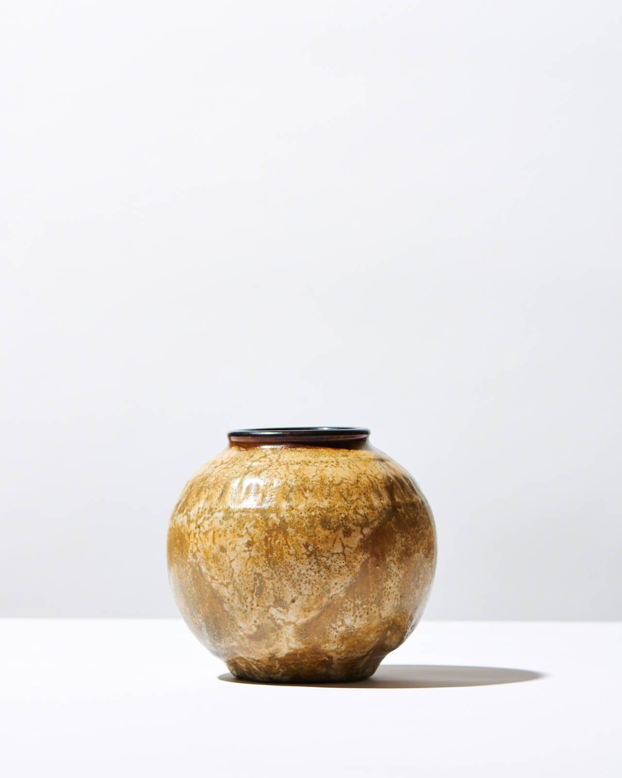 Muted colors and shades of brown, as well as rich flambé glazes are indicative of Émile Decoeur's work, and those characteristics certainly apply to this spherical enameled stoneware vase. The name attributes the idea that the vase, in its