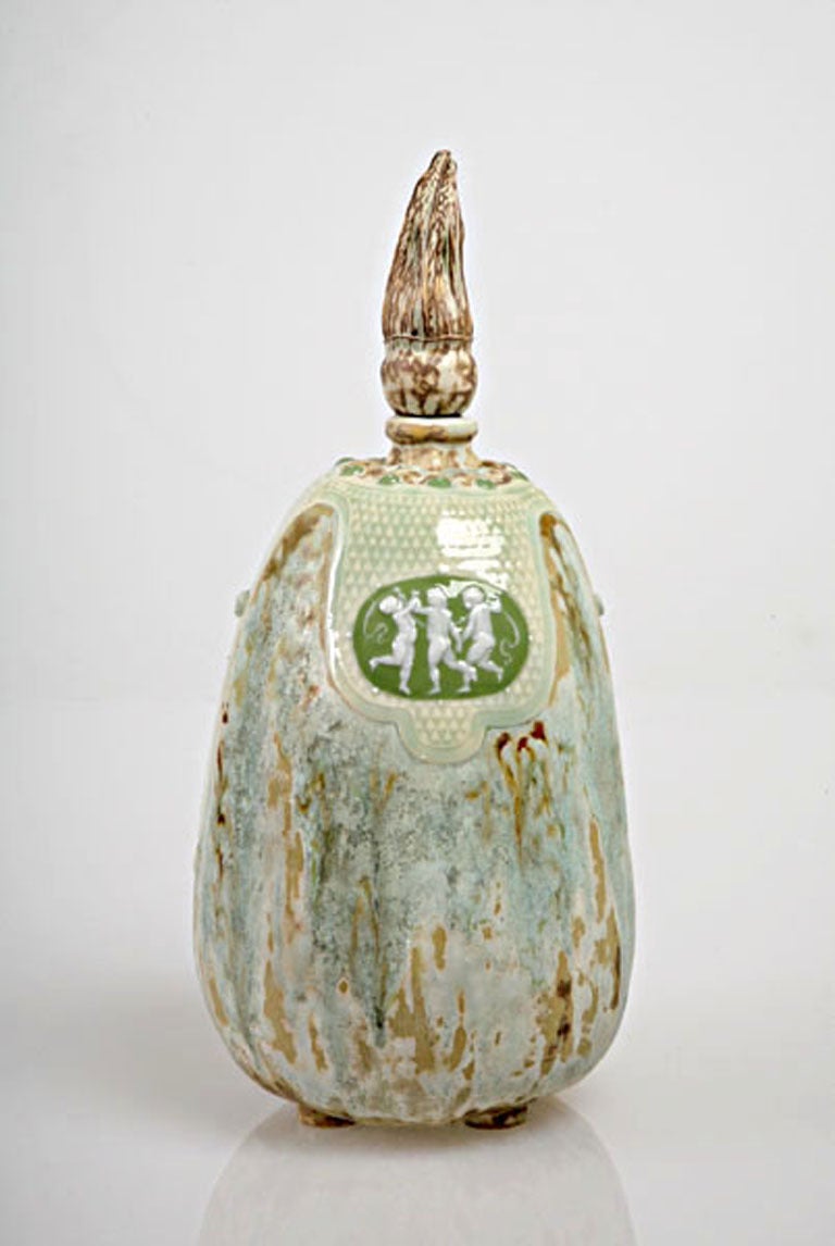 The shocking synthesis of geographically remote ceramic traditions sets this superb porcelain bottle apart from its Aesthetic-period ancestors. Here, a Japonist high-temperature drip glaze on a gourd-shaped vessel is ornamented with apple green