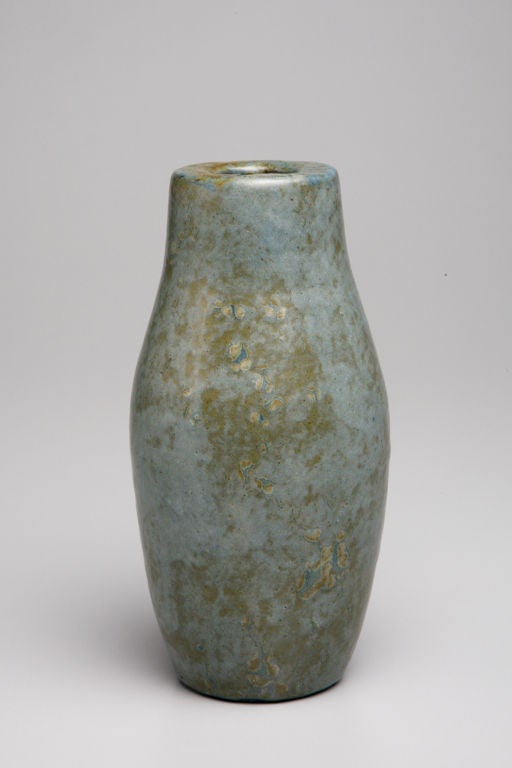 Pure and simple in form, this blue-gray vase boasts an abstract glaze composition of golden streaks and speckles that suggest the transformation of a base metal into gold. Created in the Japonist tradition during the Art Deco era, the shape and
