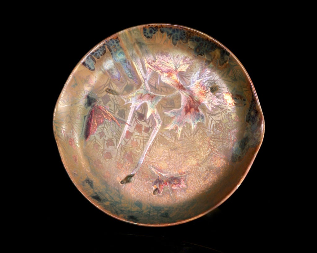 With its gently tapering sides and pulled edges, this shallow dish exemplifies Lévy-Dhurmer's use of layered glazes and etched designs to create evocative Symbolist compositions. By juxtaposing brilliant and dull luster pigments, the foliage