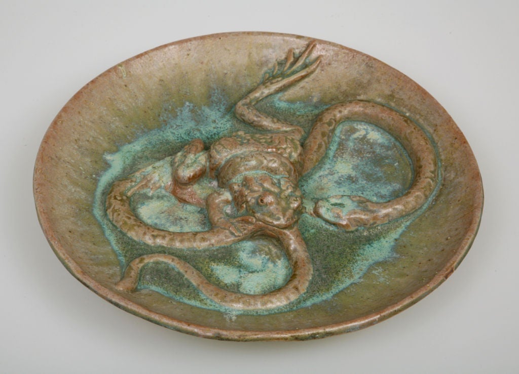 This sculptural dish was intended as an artwork rather than as a functional object. Here, a carefully articulated frog attacks a helpless snake. The blue curdled glaze suggests water, an effect that could have been heightened by adding actual water