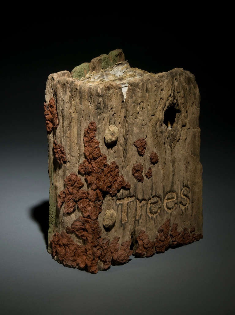 This weathered looking book sculpture that imitates the look of a birch trunk is created from meticulously carved stoneware by Eric Serritella. Who creates ceramic trompe l'oeil Works in the Japanese Yixing style from hand-built and unglazed in clay