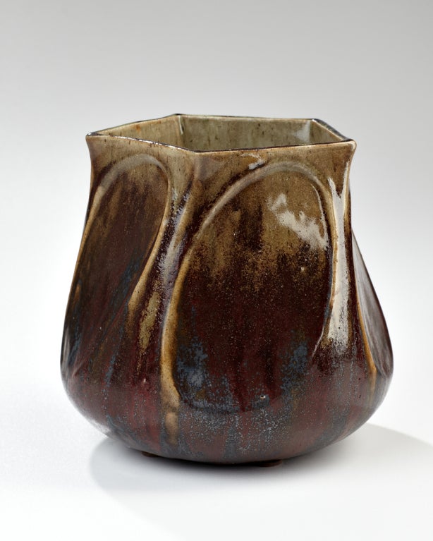 This vase starts perfectly round at the bottom and geometrically twists into a pentagonal top. The five sides are highlighted by the glaze loss like skin baring the bones of the vase. Marks: Stamped artist's name, Les Grands Feux de Dalpayrat.