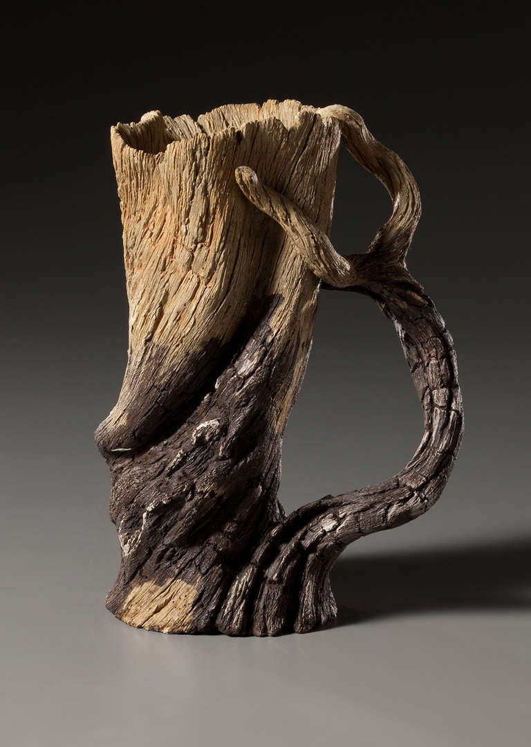 This sculptural mug has the natural quality of charred, weathered wood, but is created from meticulously carved stoneware by Eric Serritella. Serritella creates ceramic trompe l'oeil Works in the Japanese Yixing Style from hand-built and unglazed in