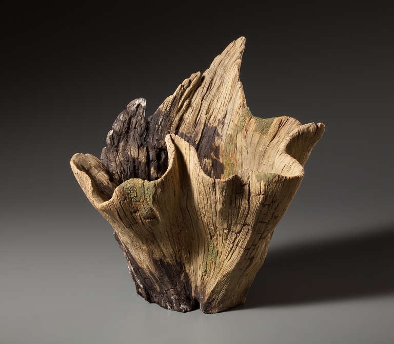 This sculptural vase has the natural quality of aged, worn wood, but is created from meticulously carved stoneware by Eric Serritella. Serritella creates ceramic trompe l'oeil Works in the Japanese Yixing Style from hand-built and unglazed in clay