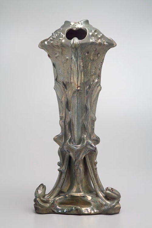 This sculptural vase was designed by Louis Majorelle, a man famed for his organic furniture, and produced by the manufacturer Keller et Guèrin. Both the designer and the firm were key players in L'Ecole Nancy, a gathering of artists and