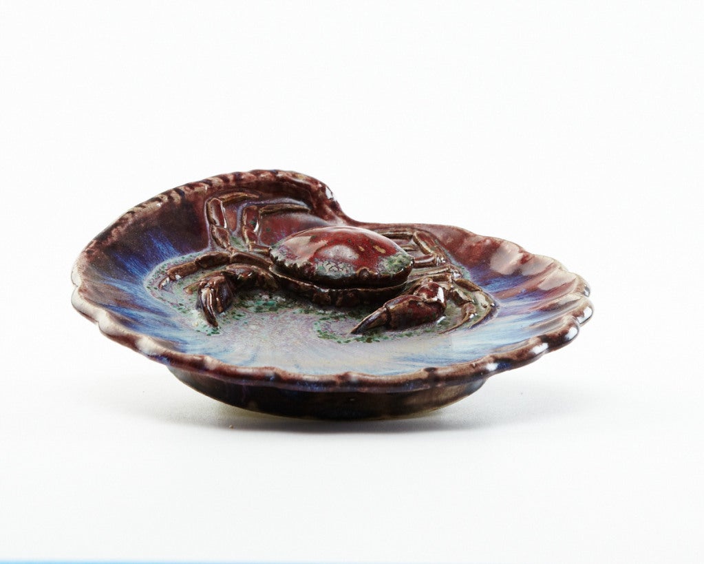 Like many of his contemporaries, Lachenal was reinventing traditional Japanese ceramic forms, including ubiquitous sea life motifs. This piece features a red crab that functions as an inkwell in a vibrant blue shell. The colors greatly enhance the