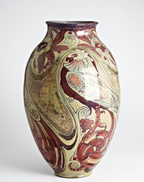 This stunning vase designed by Galileo Chini, circa 1906-1911 and created circa 1920, is richly decorated with hand-painted swirling designs and three stylized parrots feasting on pomegranate seeds. Leafy branches bearing split open pomegranates