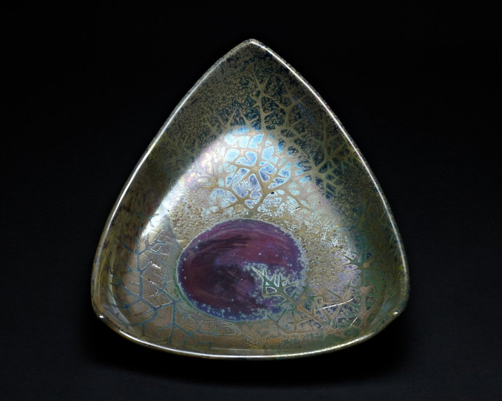 The décor on this triangular charger superbly demonstrates Lévy-Dhurmer's Symbolist aesthetic. The dark moon, partly obscured by brambles, suggests a night sky observed in a dream or a vision. In both his ceramics and paintings, Lévy-Dhurmer