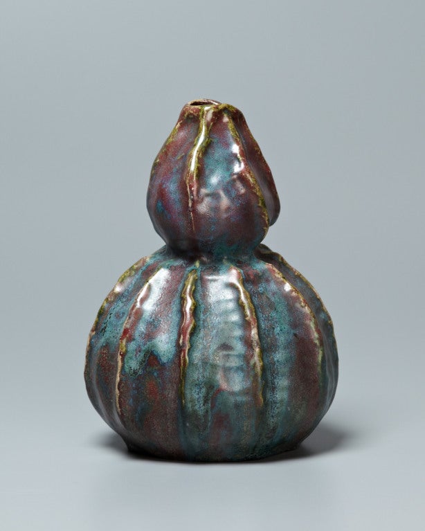 Here an exquisite naturalism has been overlaid upon a traditional far eastern lobed vase form. Every ripple and indentation of the gourd has been lovingly depicted, transforming a traditionally abstracted Silhouette into an almost living thing,