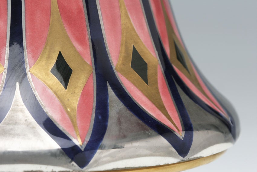 A beautiful pink flower seems to be set upon the lid of this covered dish, its petals spreading with geometric precision as it reaches the rim. Stylized nature depicted in luscious colors and accented in gold was Karl Klaus's specialty and of