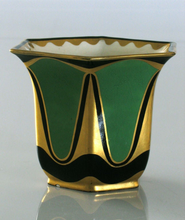 Vase with a hexagonal everted lip, decorated with white, green, and black enamel glazes, highlighted by burnished gold detailing. The form and decoration are in the manner of Viennese designer Karl Klaus. Made in Turn-Teplitz, Bohemia, circa 1911.