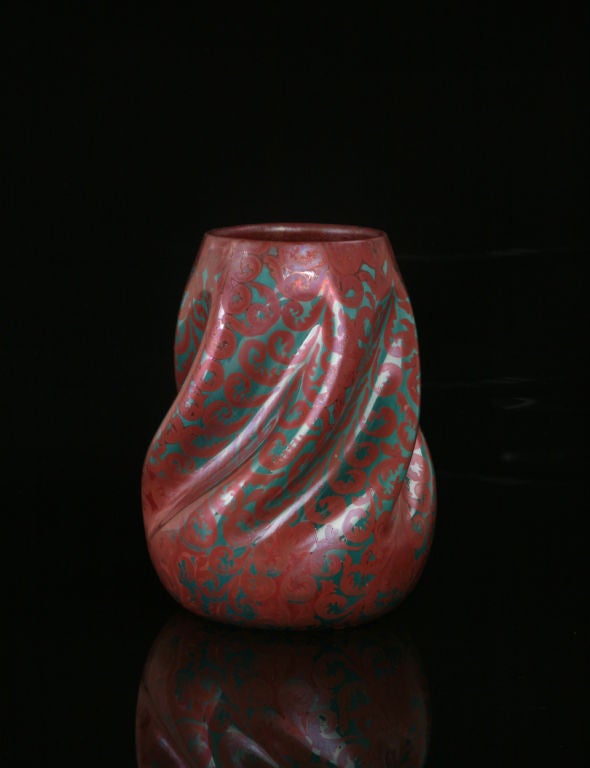 Like many of Massier's early luster pieces and the Hispano-Moresque wares that inspired them, this vase makes the most of only two colors. Here, red ferns unfold in graceful arabesques against an iridescent turquoise underglaze. The body-twist