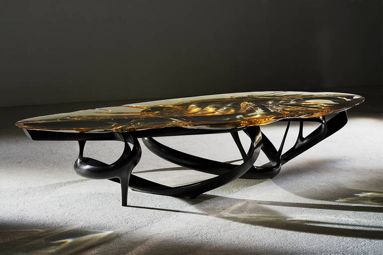 The ‘Lumenoria’ dining tables are cast Resin surfaces over free-form wood sculptural bases. The resin is cast through a process of physical form-finding; allowing the liquid resin to respond to the wood form beneath creating an undulating, organic