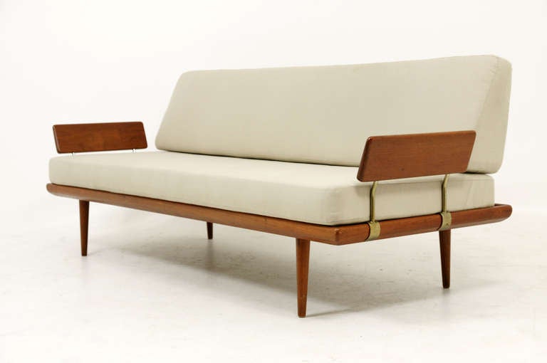 Stunning solid teak sofa designed by the duo of Peter Hvidt and Ola Molgaard-Nielsen. Part of the Minerva series, this sofa matches corner table and several other tables in the same line and designed in 1955. The sofa is solid teak throughout and