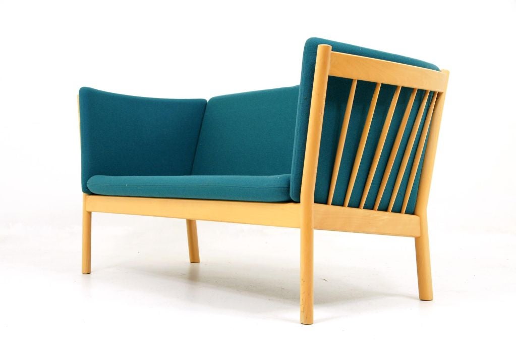 Solid beech wood framed, 2 seater sofa designed by Erik Ole Jorgensen and produced by Kvist Mobler. Original wool cushions are a vibrant turquoise blue and in remarkable condition. Please see matching chair model J147 in our other listing.