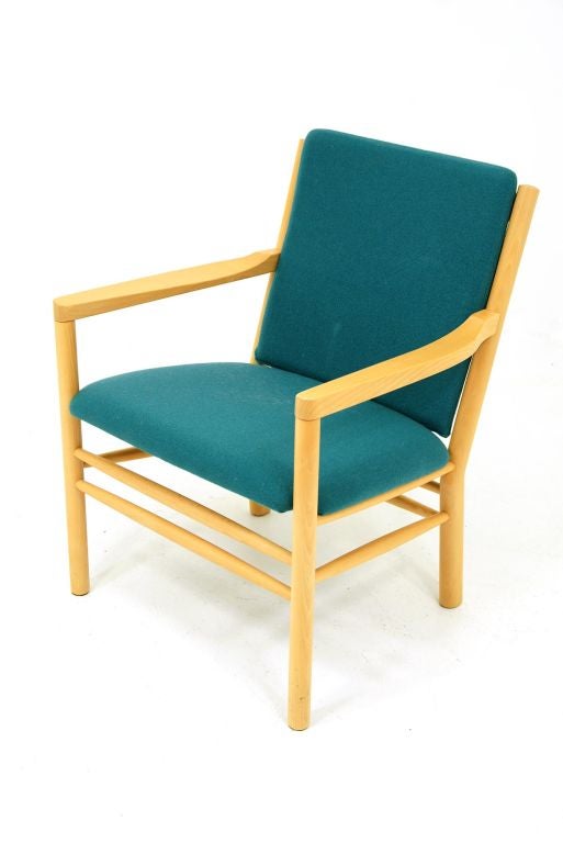 Solid beech wood framed, arm chair designed by Erik Ole Jorgensen and produced by Kvist Mobler. Original wool cushions are a vibrant turquoise blue and in remarkable condition. One small mark to back cushion. Please see matching sofa model J148 in