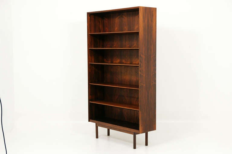 Gorgeous rosewood open bookcase or bookshelf. Shelves are adjustable and bookcase sits on four turned legs. Very high quality bookcase with lovely details around the edges. Rosewood veneer has stunning grain. Condition is original and excellent.