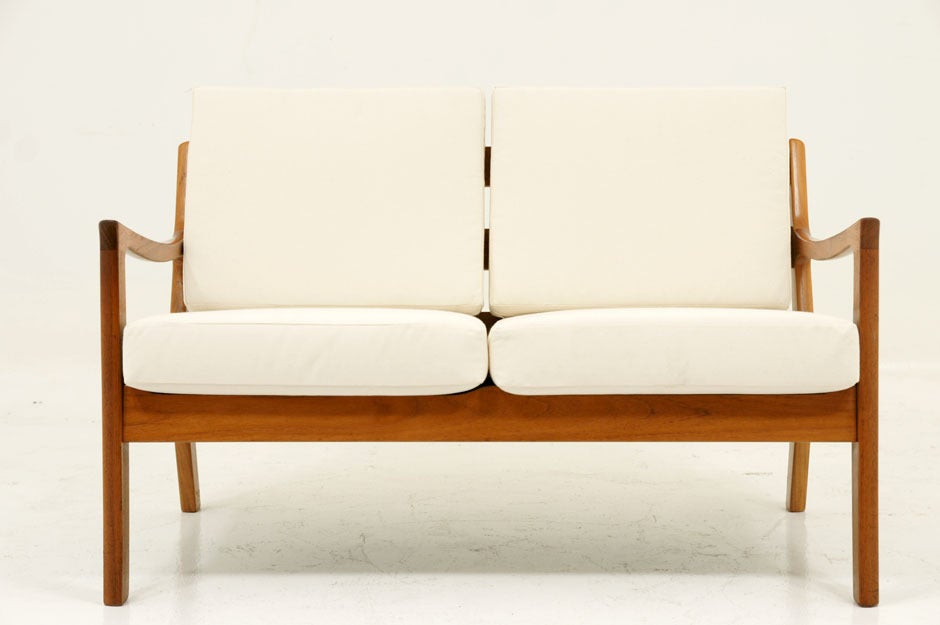 Gorgeous 2 seat love seat or sofa designed by Ole Wanscher and produced by well known cabinet making firm P. Jeppesens Mobelfabrik. Designed in 1961 this sofa is part of the Senator series of seating. The cushions and fabric have been re-done and