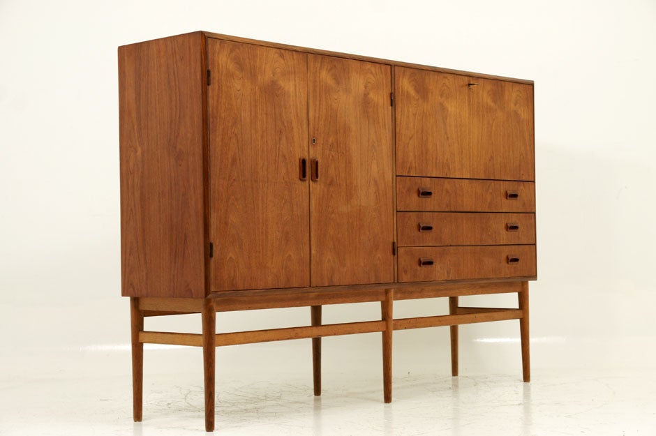 Very unusual teak sideboard buffet cabinet attributed to Borge Mogensen. Showing Mogensen’s signature pulls throught, this cabinet has so many storage options. Whether it be the large doors opening onto shelving within or the drop door with drawers