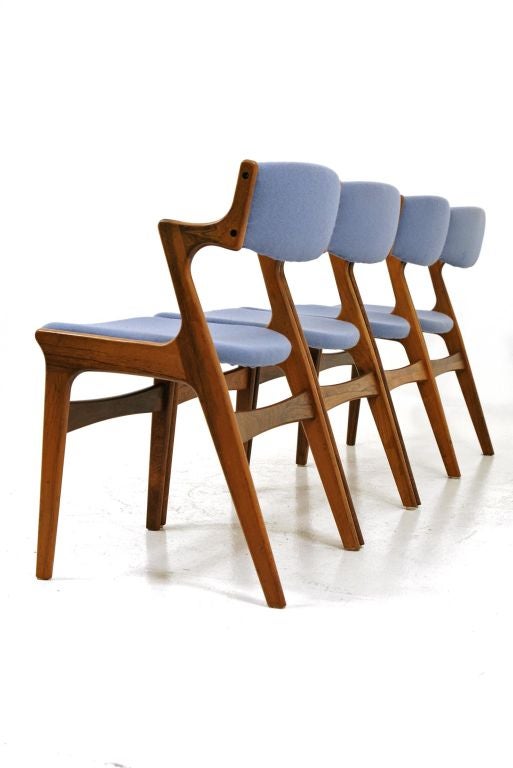 Set of 4 dining chairs in rosewood and made by Nova Mobler. Unusual armrests show the finger joint detail. Excellent condition and upholstery is servicable but could use updating.