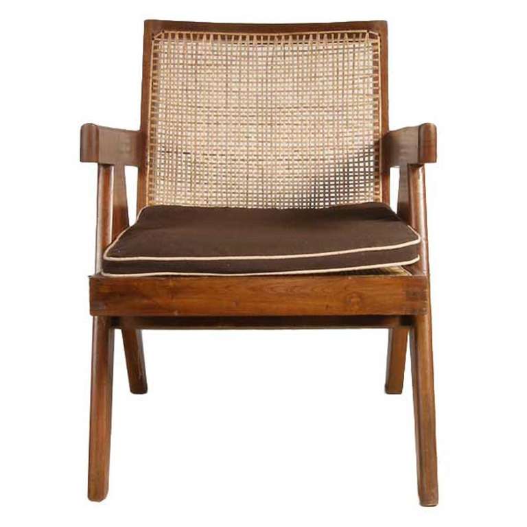 This mid-century modern low, lounge chair has a solid teak frame, with a low, caned backrest and seat, straight arms and is raised on scissor legs.

Literature: E. Touchaleaume and G. Moreau, Le Corbusier Pierre Jeanneret: The Indian Adventure,