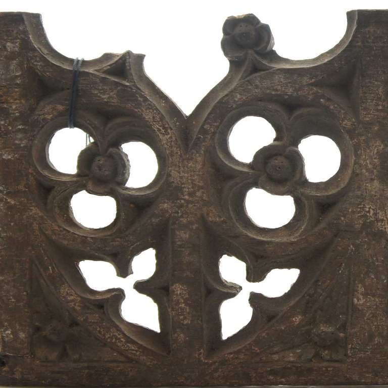 An architectural openwork fragment with two pointed arches pierced with trefoil and foliate openings and retaining traces of paint.  This is a rare late Gothic period blind tracery decoration from a wall panel.

Provenance: Chatsworth House