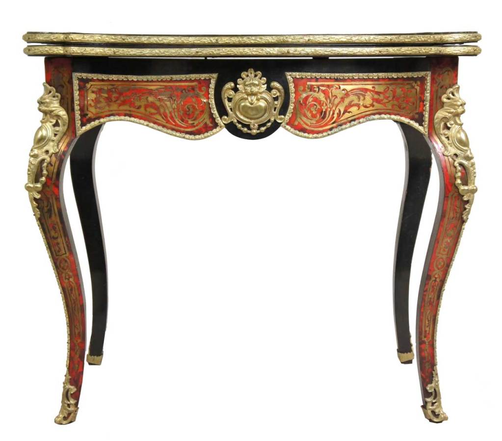 This elegant occasional table has a serpentine fold-over top, with a green felt-lined playing surface to the reverse. The cupid's bow frieze is centered by lion mask shields and is similarly decorated to the reverse. It is raised on cabriole legs