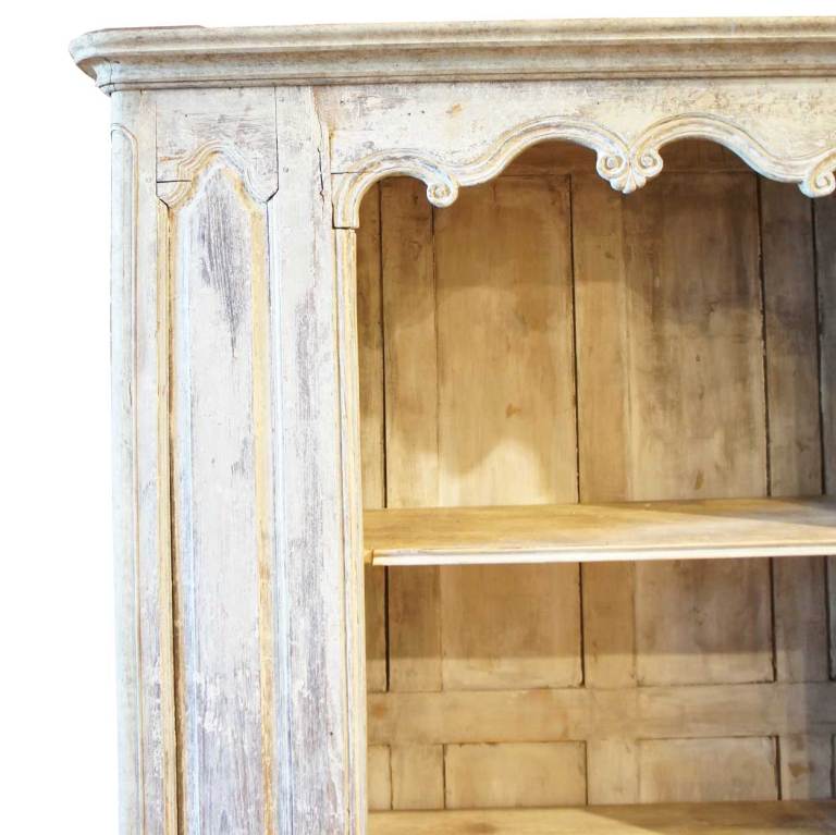 This white painted, display cabinet or bookcase displays a moulded cornice above a conforming, paneled case enclosing open shelves, on a plinth base. It offers great display space and storage.