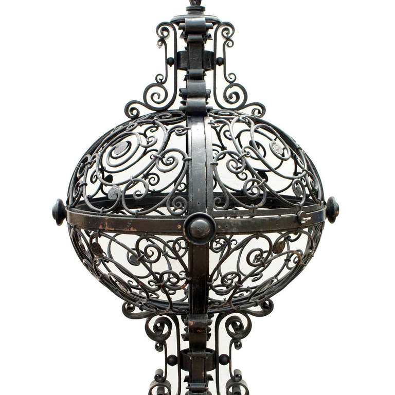 From a Chicago, Illinois lakeside estate, this pair of 19th century finials would have flanked a grand driveway gate.  Each features a spiral finial above a large, flattened ball of openwork C-scrolls and is supported on four legs. They could be