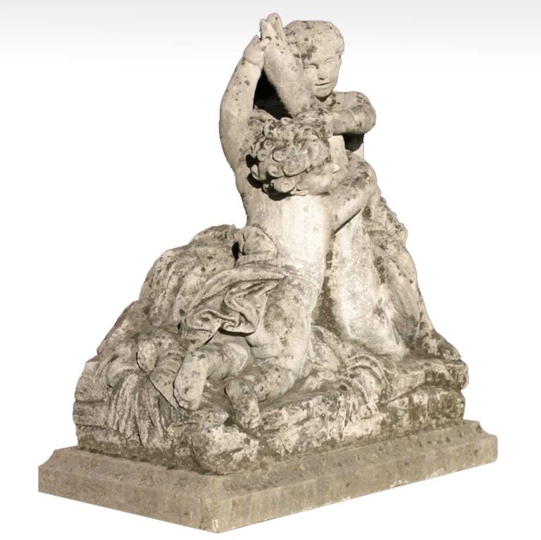 Hand carved, two centuries ago, this charming grouping depicts two, chubby cherubs wrestling a large goose. It is an animated portrayal that retains remarkable detailing despite a soft patina of age, including some coveted lichen buildup. It will be