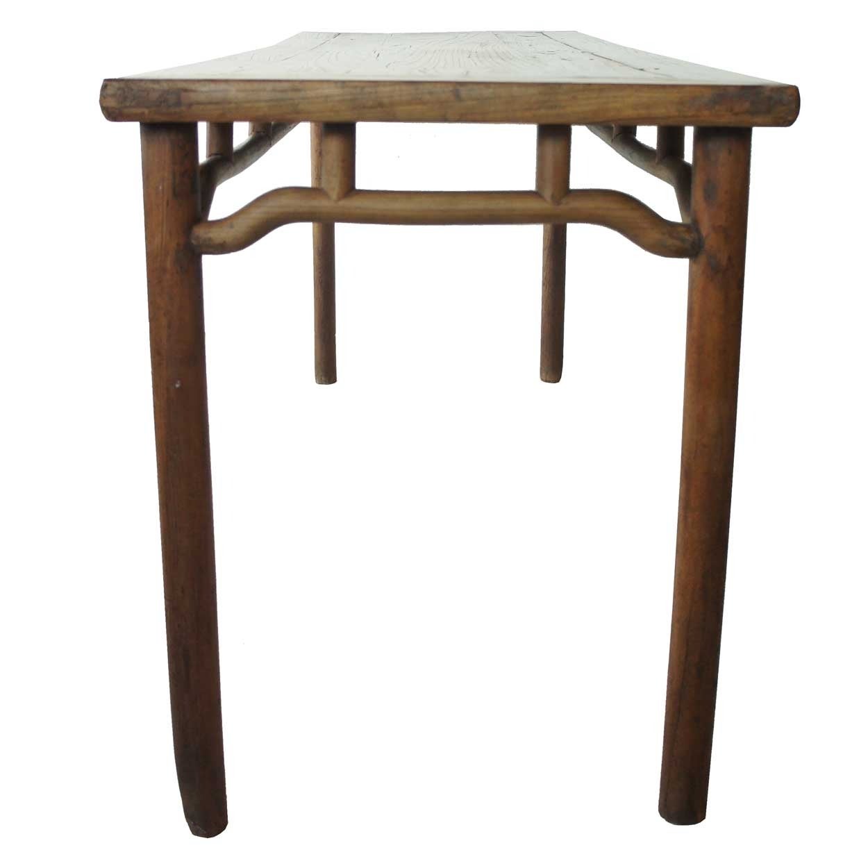 Qing dynasty (1644-1912).
This early, antique Chinese table was handcrafted and designed with the simplest, almost contemporary lines. It features a floating panel on the top and pole-form legs and box and humpback, H-stretchers that form an open