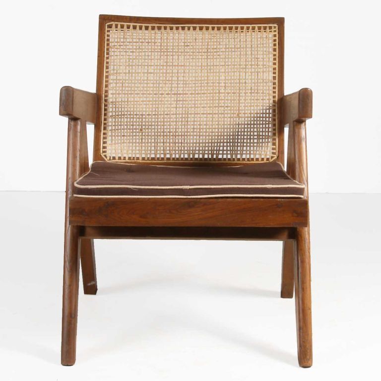 Pierre Jeanneret (Swiss, 1896-1967)<br />
This mid-century modern low, lounge chair has a solid teak frame, with a low, caned backrest and seat, straight arms and is raised on scissor legs.<br />
Seat: H 14.5
