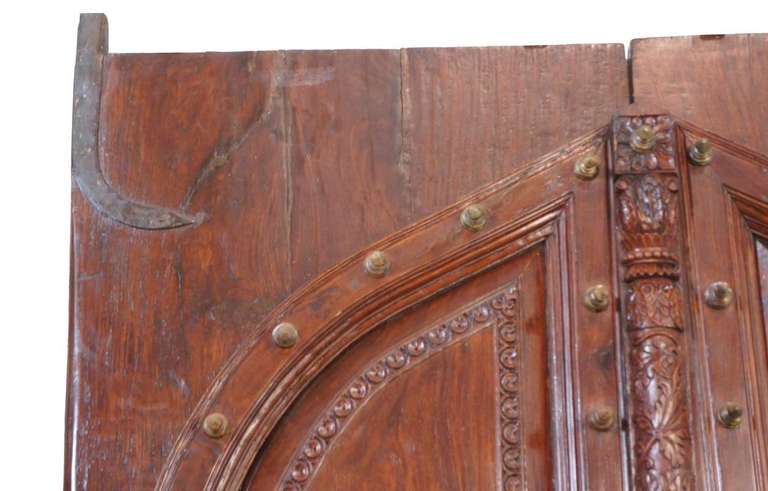 These very heavy, solid rosewood doors are the finest we have ever found. They once formed the grand entry to a British building in the time of the Raj in Southern India. They are designed like palace doors or doors from the finest Portuguese