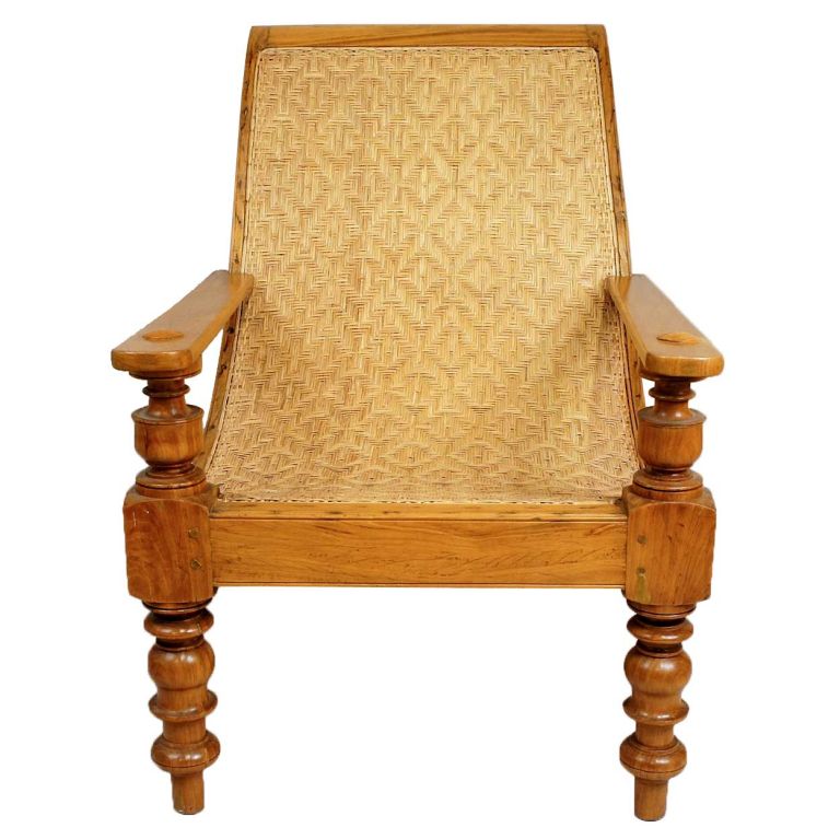 This Anglo Indian chair is hand crafted of solid satinwood, a precious wood generally reserved for inlay or veneer. This form of reclining chair was unique to the colonies during the Raj period and used primarily on verandas. This example displays