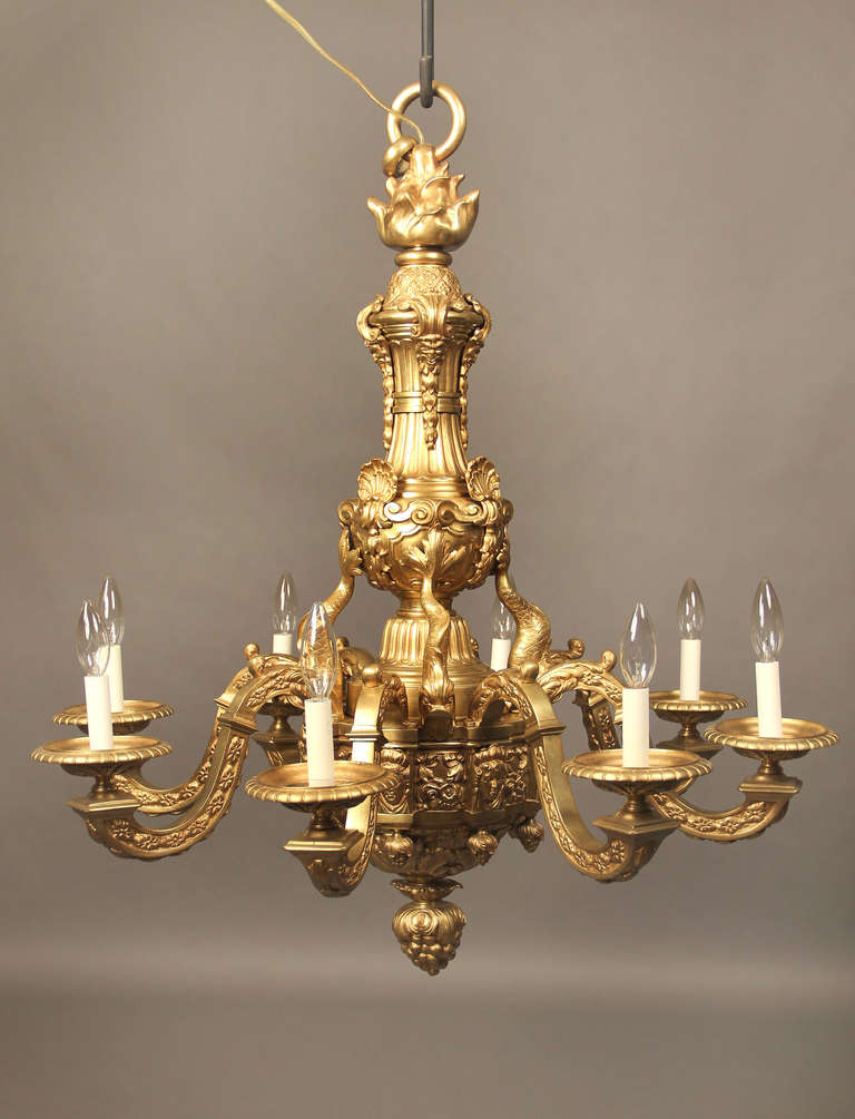 Late 19th century gilt bronze eight-light chandelier.

Heavy bronze casted, decorated with female masks, shells and dolphins.

If you are looking for a chandelier, a lantern or sets of sconces, Charles Cheriff galleries is the right place to