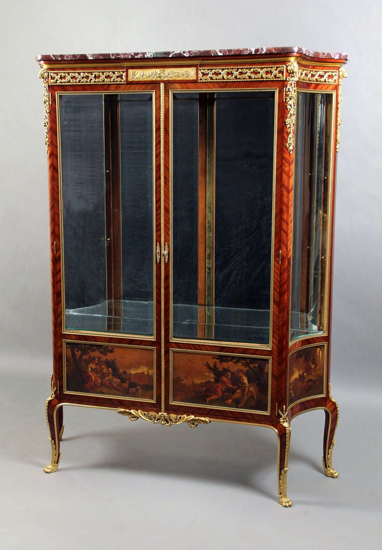 A fine quality late 19th century Louis XV style gilt bronze mounted two-door Vernis Martin Vitrine

Surmounted by a marble top above a frieze with scrolling foliage, above two glass doors with Vernis Martin panels, flanked to each side by a glass