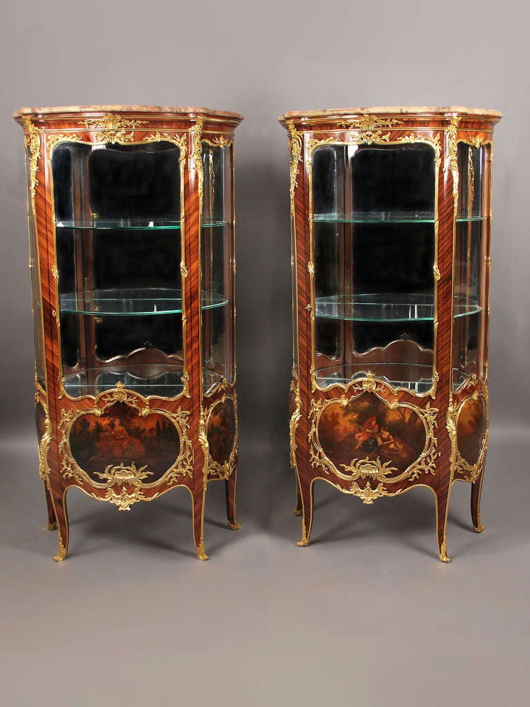 A superb pair of late 19th century louis xv style gilt bronze mounted Vernis Martin Vitrines.

By François Linke.

Each with Brèche d'Alep marble top, glass door with a Vernis Martin painted panel Watteauesque scene, both side panels also with
