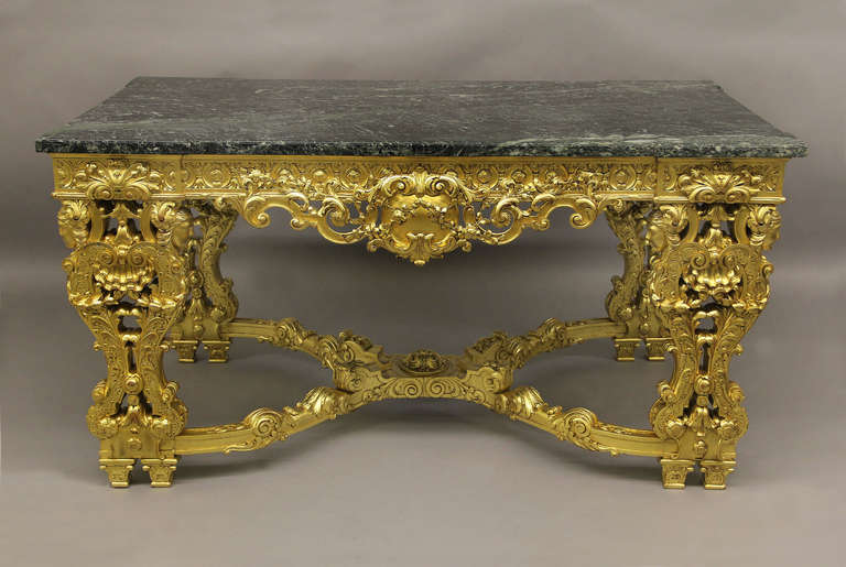 A very fine late 19th century hand-carved Regence style giltwood center table.

With legs headed by female busts, a wavy 
