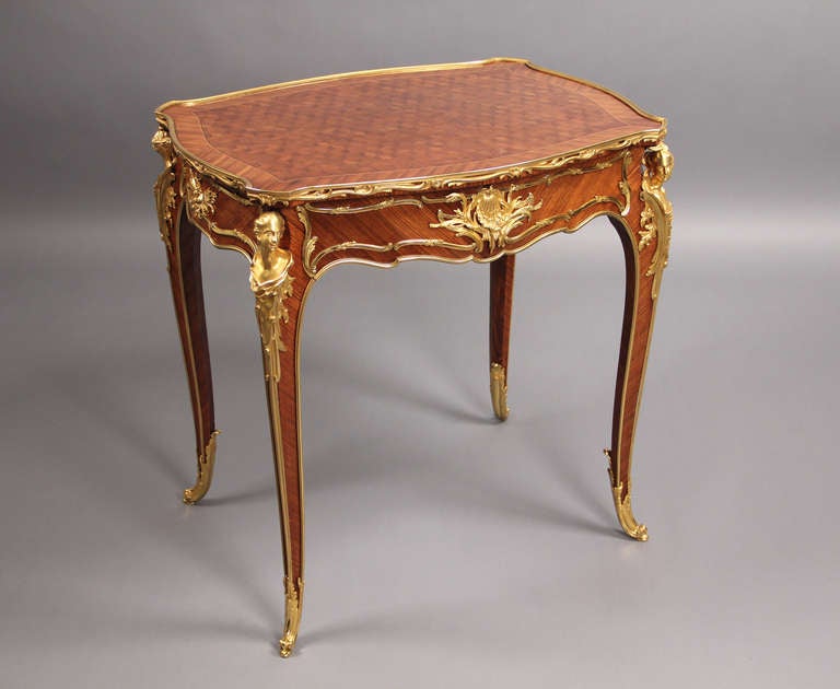 A Very Fine Late 19th Century Louis XV Style Gilt Bronze Mounted Parquetry Lamp Table

By François Linke

Beautiful inlaid parquetry top, above a single drawer, each leg is adorned by a male and female bust. The front bronze of the classic Linke sea