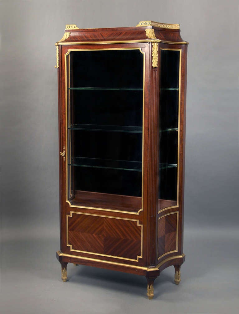  A Fantastic Late 19th Century Gilt Bronze Mounted Louis XVI Style Vitrine
By Victor Raulin

A center glass door with three shelves, quartered veneer bottom and sides.

Stamped Raulin twice on the top, back of the carcass.

Raulin exhibited and