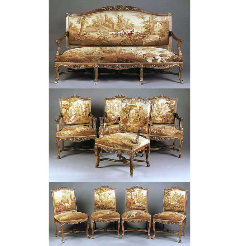 A fantastic late 19th century nine-piece Louis XV style parcel-gilt carved walnut and Aubusson Tapestry Parlor set.

Consisting of four side chairs, four armchairs and a settee, each with serpentine back, shell crest, cabriole legs joined by