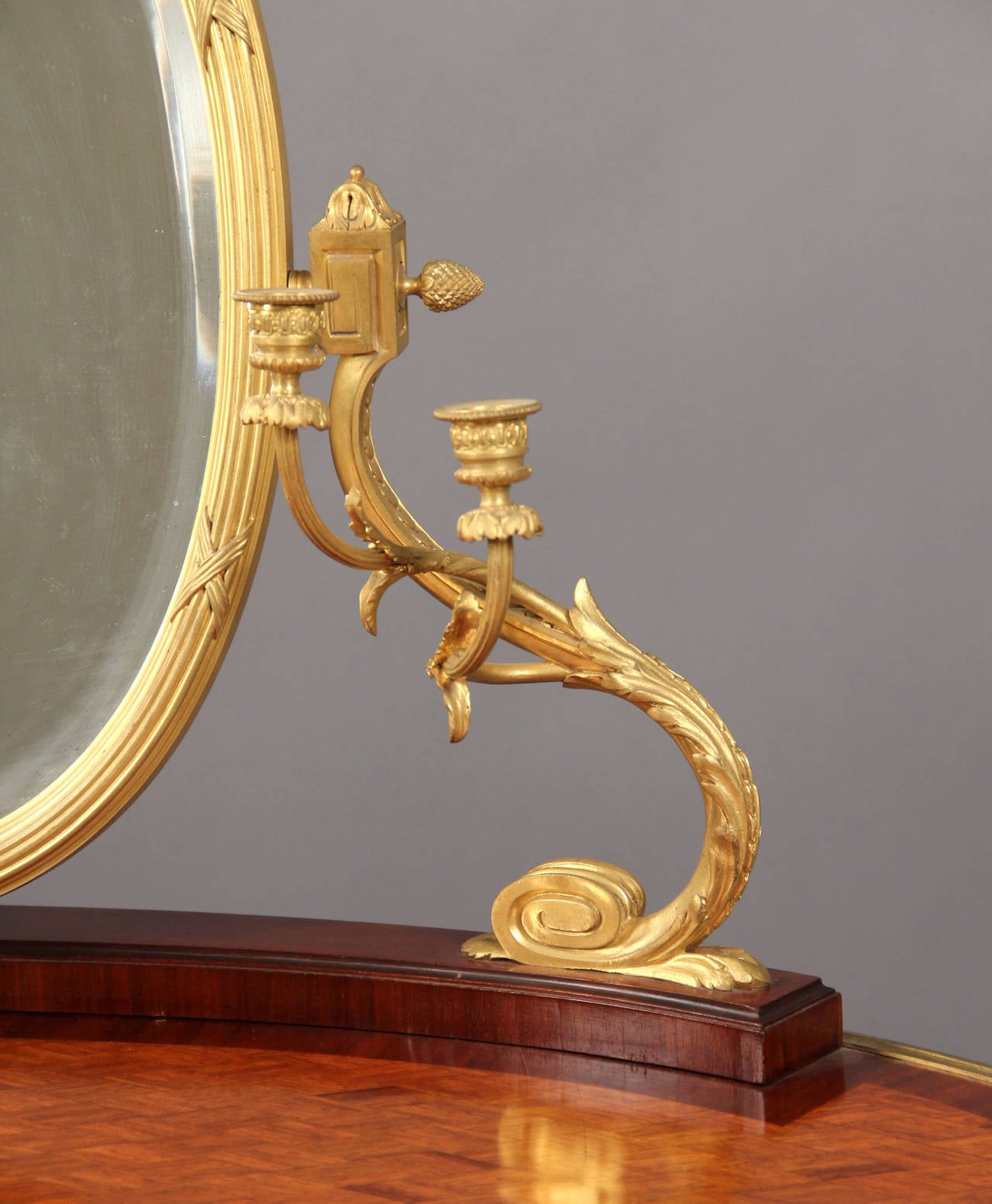 Late 19th century gilt bronze-mounted Louis XV style dressing table.

Kidney shaped parquetry top, supporting an oval bronze bevelled mirror flanked by two scrolling candelarms, above three drawers.