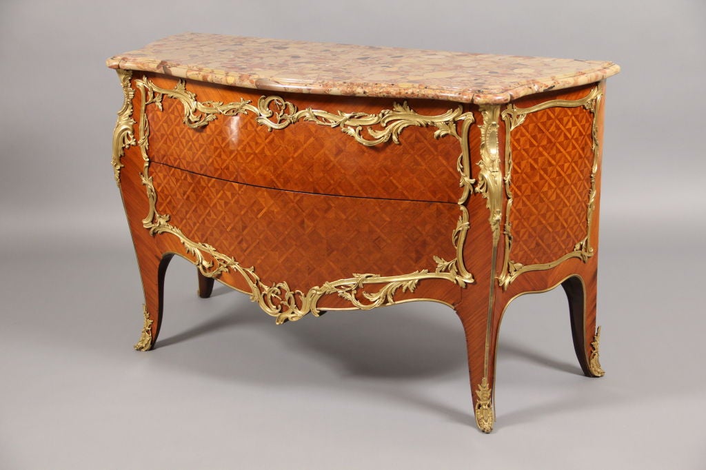 Late 19th Century Louis XV Style Gilt Bronze Mounted Parquetry Commode

Brèche d'Alep marble top above two deep bronze mounted parquetry drawers.