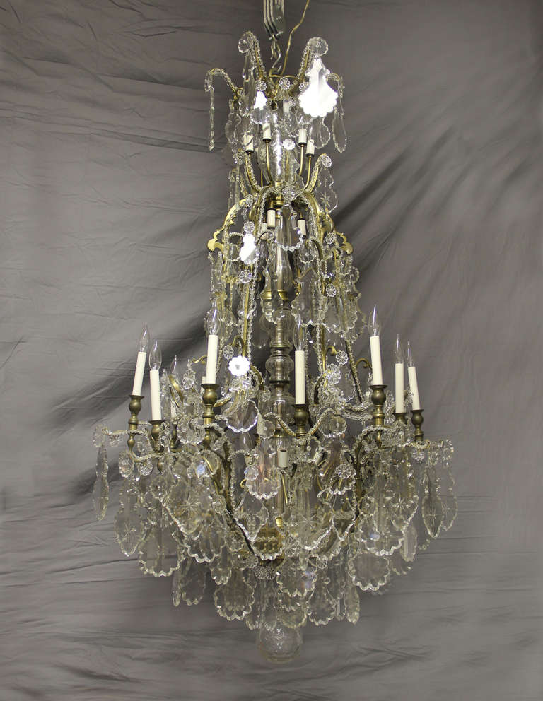 A wonderful and impressive late 19th century gilt bronze and baccarat crystal twenty-eight light chandelier.

Multi-faceted and shaped crystal, beaded arms, cut crystal central column, twelve perimeter and sixteen tiered interior lights.

If you