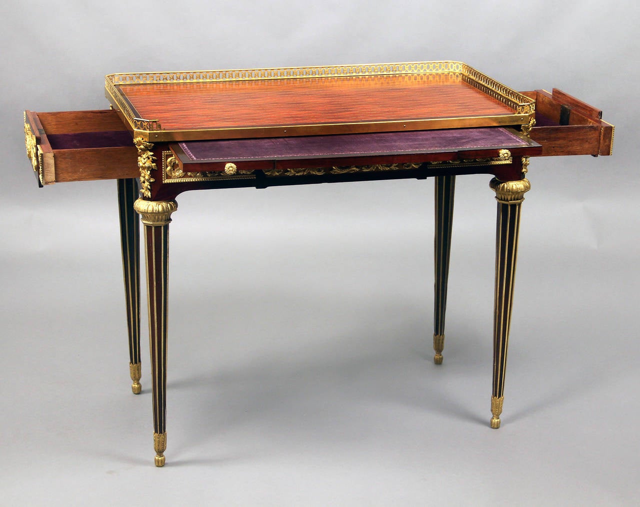 A very Fine late 19th century gilt bronze-mounted Louis XVI style mahogany and sycamore writing table

by Maison Millet

Diamond parquetry top above a foliate scrolled frieze with a velvet lined pull-out writing slide. Each side similarly