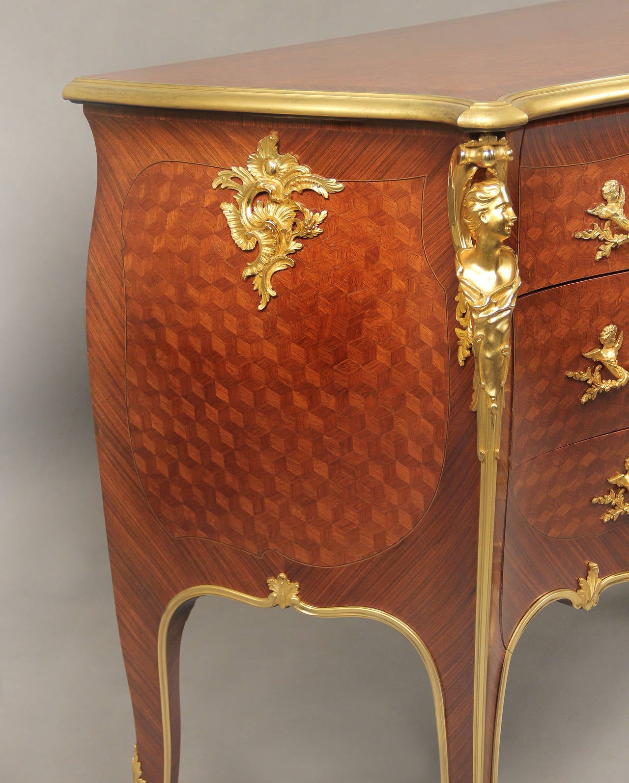 A wonderful and rare early 20th century Louis XV style gilt bronze mounted commode.

By François Linke.

Index number 1405.

The shaped serpentine cube parquetry top over bombe case with cube parquetry front and sides, the front with sans