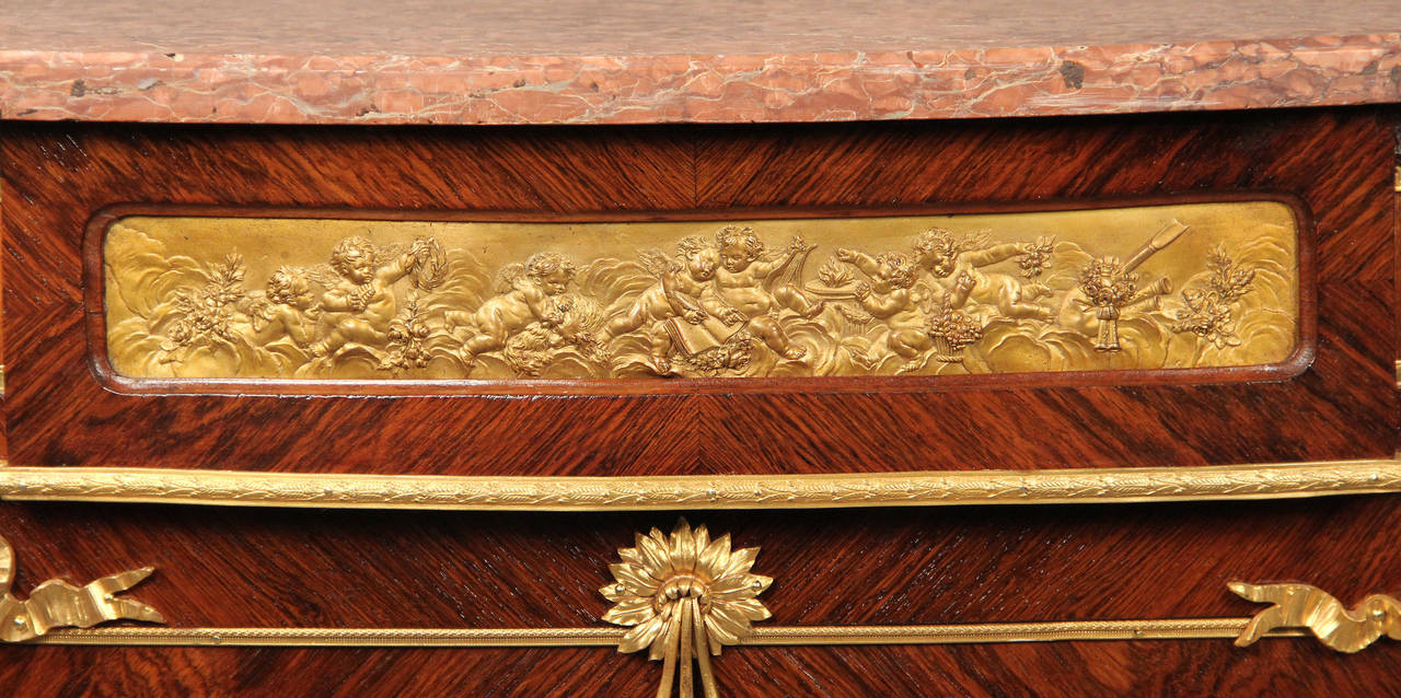 A nice late 19th century gilt bronze-mounted kingwood Louis XVI style cabinet.

The demilune shaped red marble top above the frieze and a door enclosing shelves applied with gilt bronze floral swags on spirally fluted circular tapering legs.